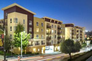 Exterior of building lit up at night from street