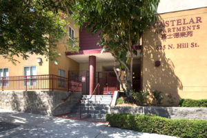 Castelar exterior with double stairway, sidewalk, and 625 N. Hill St