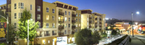 Exterior of building lit up at night from street