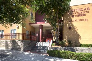 Castelar Apartments with 625 N Hill St on exterior, double staircase, and sidewalk