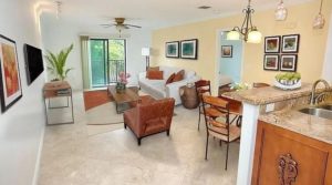 bright living room with large window, balcony, tile flooring