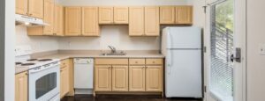 Crescent Cove kitchen with light brown cabinets and white applicances