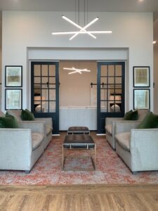 clubhouse lounge seating. contemporary space, neutral tones, sliding door leading to more seating