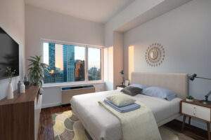Unit Bedroom, furnished, queen size bed with nightstands on both sides, dresser with tv mounted above parallel to bed, contemporary mirror hung above headboard, potted plant in corner near window and furnace/ac.
