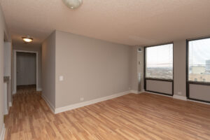 Unit Living Room, 2 large Windows, hallway from Entrance to Living room, Wood Floors, Unfurnished.