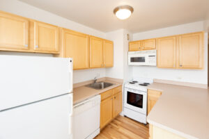 Unit Kitchen, Wood Floors, White Appliances, Light Brown Cabinetry