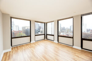Unit Living Room, Unfurnished, Windows along Perimeter of Living room, Wood floors.