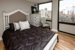 Unit Bedroom, Wood Floors, Large Rustic Dresser, Queen size bed.