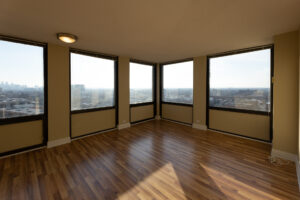 Unit Living room, unfurnished, corner unit, windows along both corner walls.