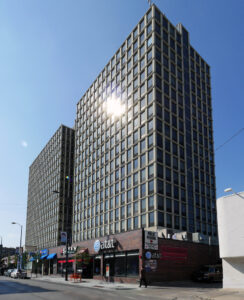 Exterior Lincoln Park Plaza, Ground view of building on a sunny day.