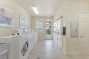 Interior Laundry facilities, white walls, tile floor, glass door.